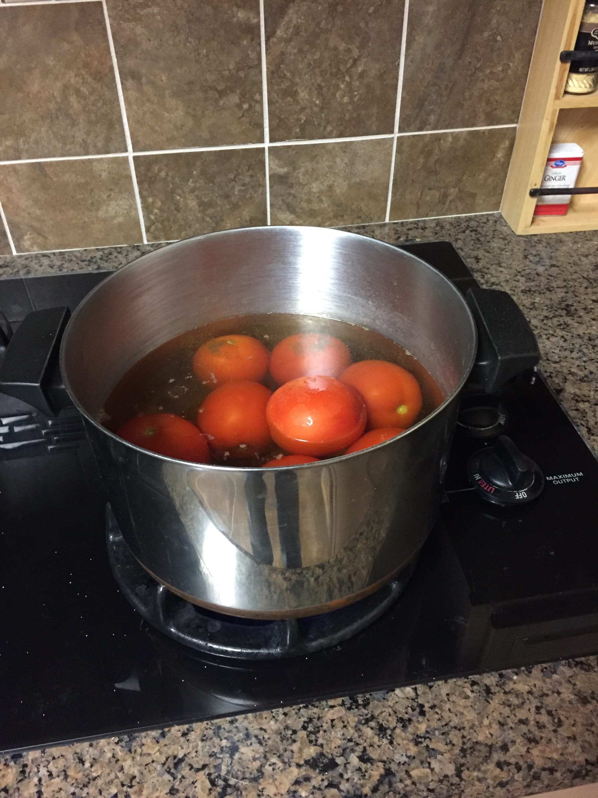 A bot ona  stove full of tomatoes
