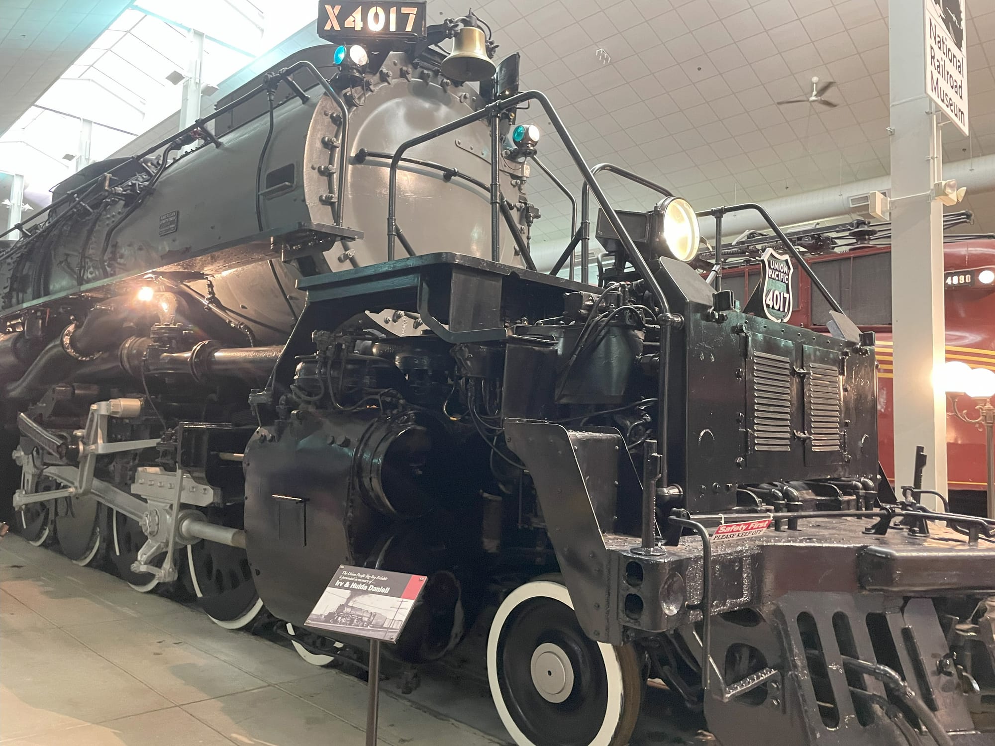 A gray and black steam locomotive with whitewhalled wheels. The number board reads X4017