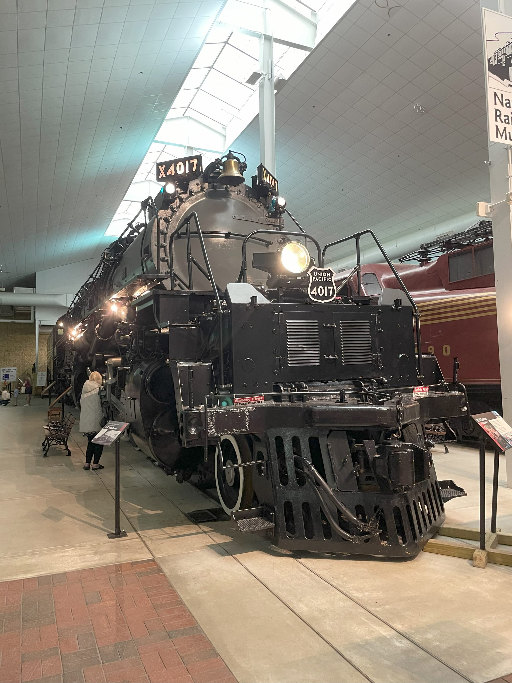 A black steam locomotive with a silver boiler and a forward headlight. A sheild under the headlight says "Union Pacific 4017"