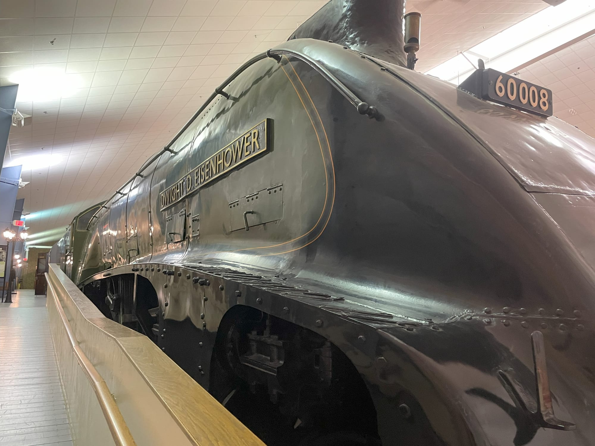 A green streamlined steam locomotive. The gold number plate on the front says 60008. The gold title on the side says "Dwight D. Eisenhower"